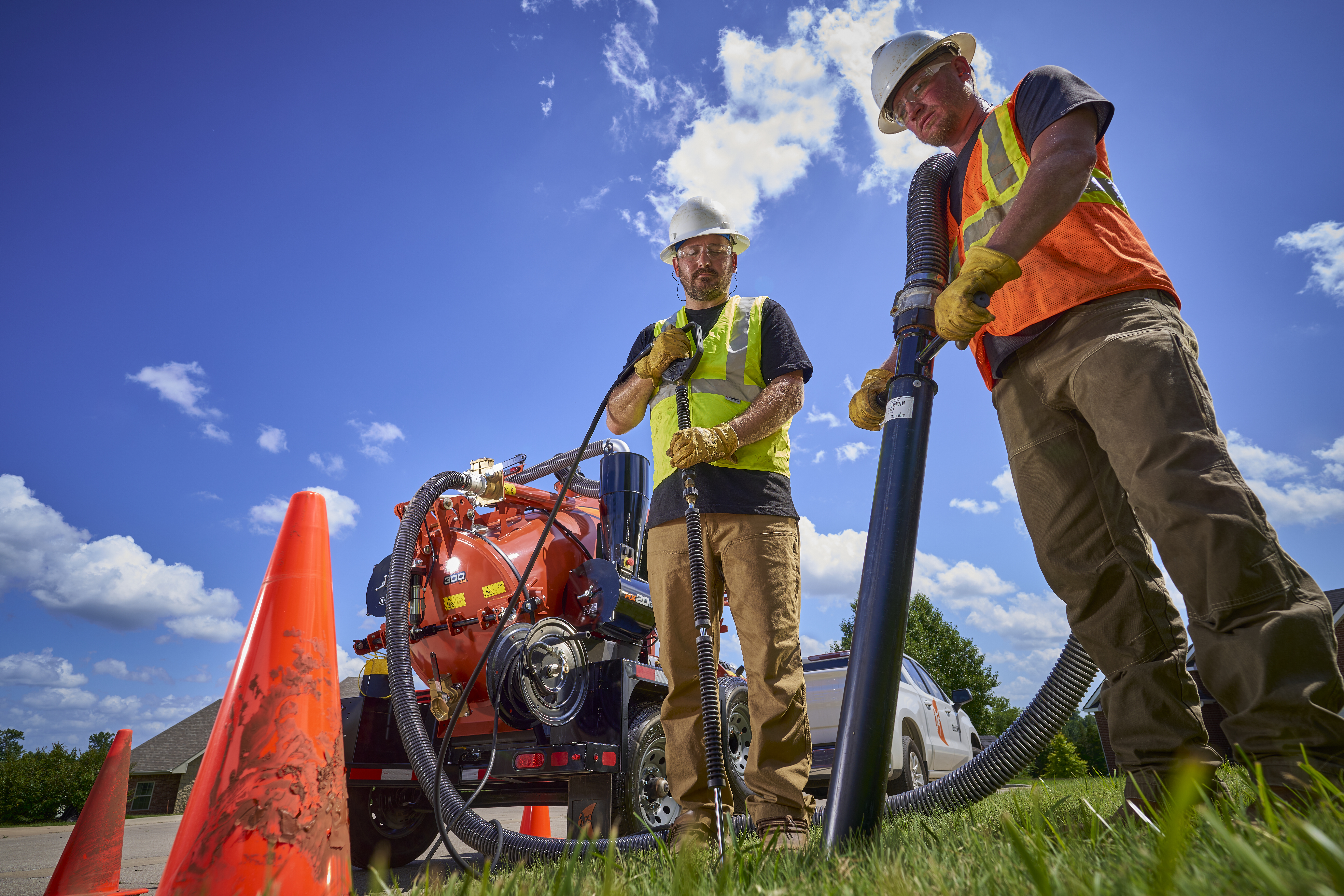 Technicians using Ditch Witch trenchless solutions equipment to safely work underground sewer lines.